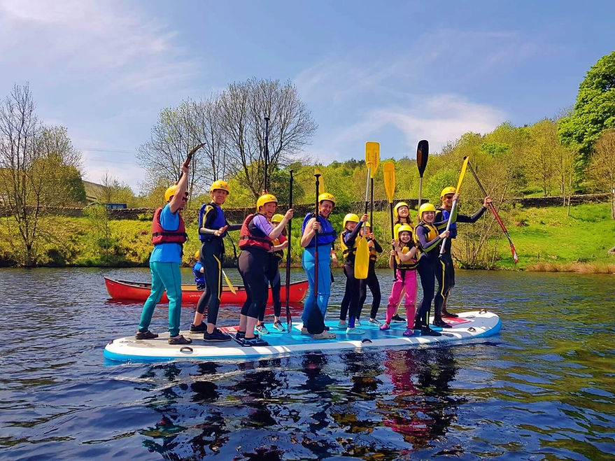 Families stand up paddleboarding