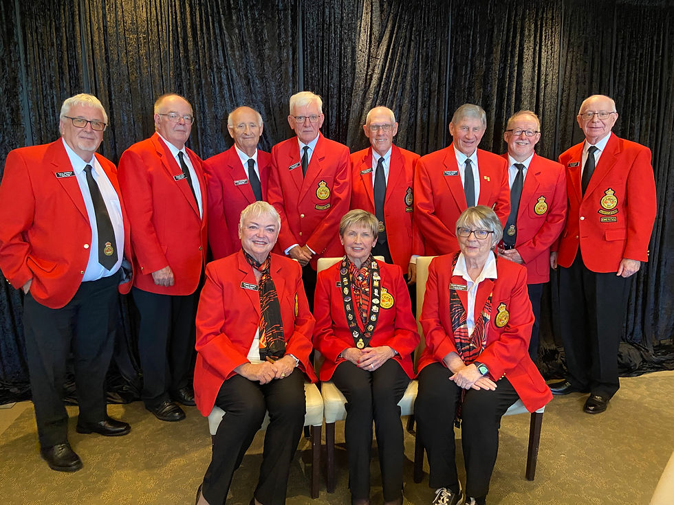 Group picture of the executive committee in their red jackets.