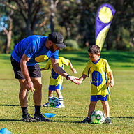 Kids playing with ball during soccer session