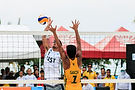 Beach volleyball players in action during a match