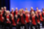 Singers dressed in red costumes