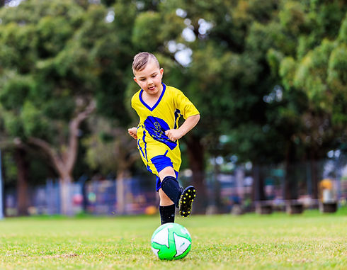 A boy playing soccer during birthday parties