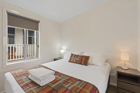 Comfortable bedroom with king bed and balcony view