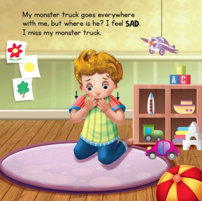  Image 1 Description: Book page with illustration of a child on a rug in his room with toys on shelves behind him, a ball and toy car on the floor, drawings on the wall, and a toy airplane hanging from the ceiling. The child signs the word "SAD" with an open-five handshape near his chin, illustrated with arrows pointing downwards from the eyes. The Text reads, "My monster truck goes everywhere with me, but where is he? I feel SAD. I miss my monster truck."