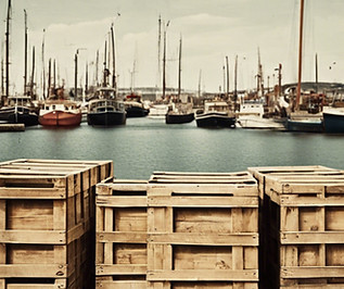 vintage photo of small dock in a harbor ' with wood shipping crates.jpg