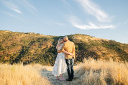 Photos of a couple standing on a mountain in Ashland, Oregon.