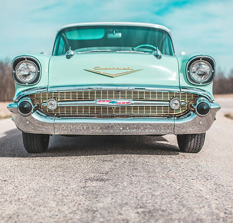 Antique turquoise car on a country road