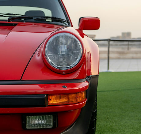 Red collector sports car parked on grass