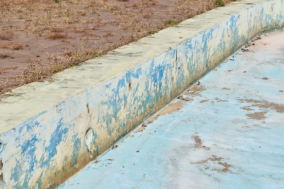 Worn Concrete Swimming Pool With Peeling Surface Coating