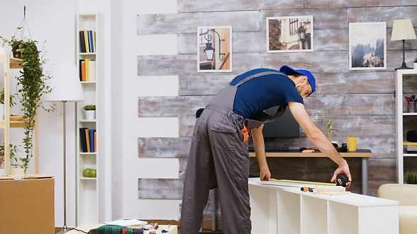 Worker Assembling A Cabinet