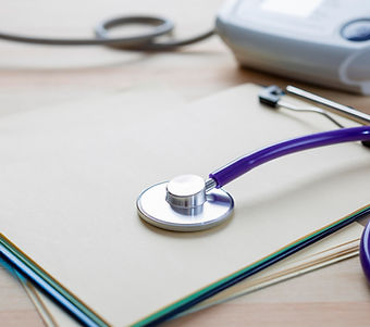 Stethoscope Resting on Medical Files in a Healthcare Office