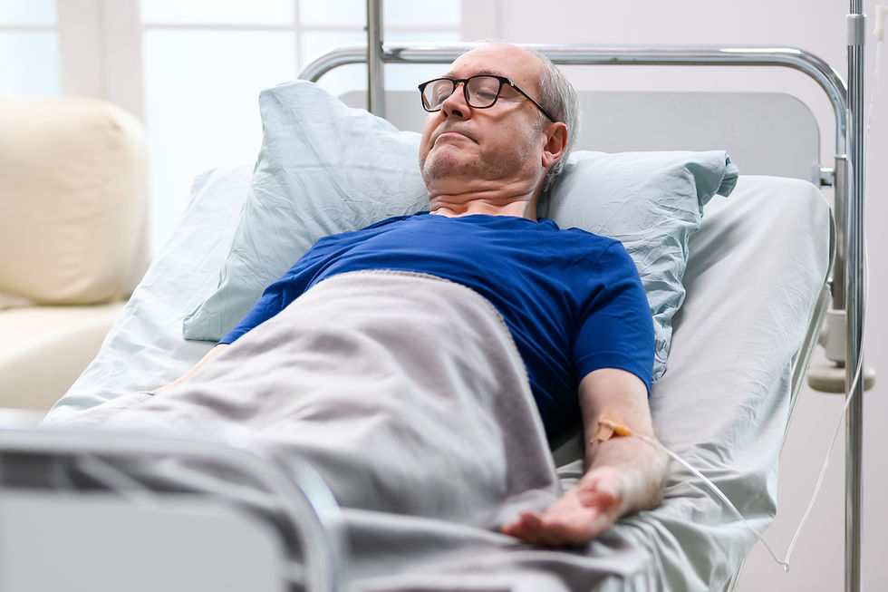 Elderly Man Resting In Hospital Bed With IV Line In Arm