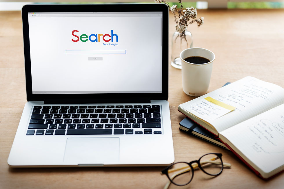 Laptop Displaying A Search Engine Homepage On A Desk Beside A Coffee Cup, Notebook, Glasses, And Workspace Accessories