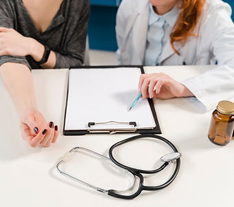 Doctor Reviewing Health Insurance Information During Patient Consultation
