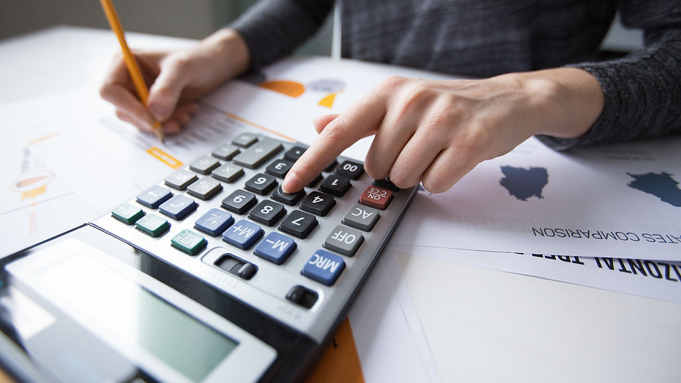 Person Using Calculator And Reviewing Financial Documents