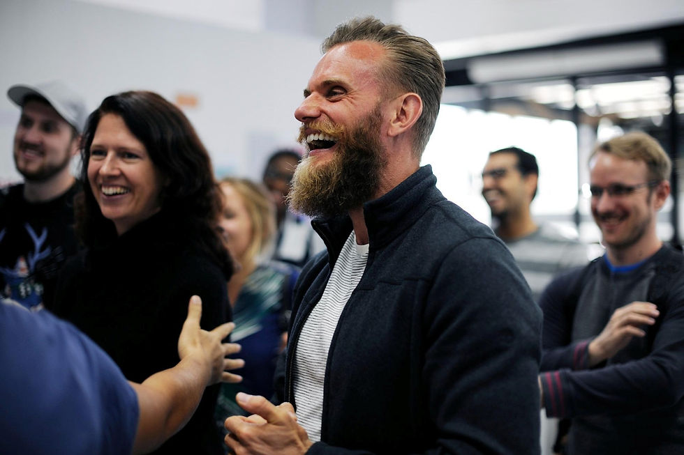Happy Professionals Laughing And Socializing At A Business Networking Event Or Team Gathering