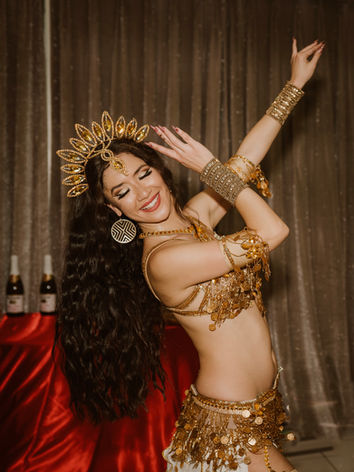 belly dancer in white and gold costume with gold crown surprise birthday party glendale