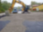 geotextile installed under gravel in road construction excavator