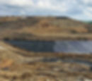 liner installers placing geocomposite drainage material over geomembrane for a landfill