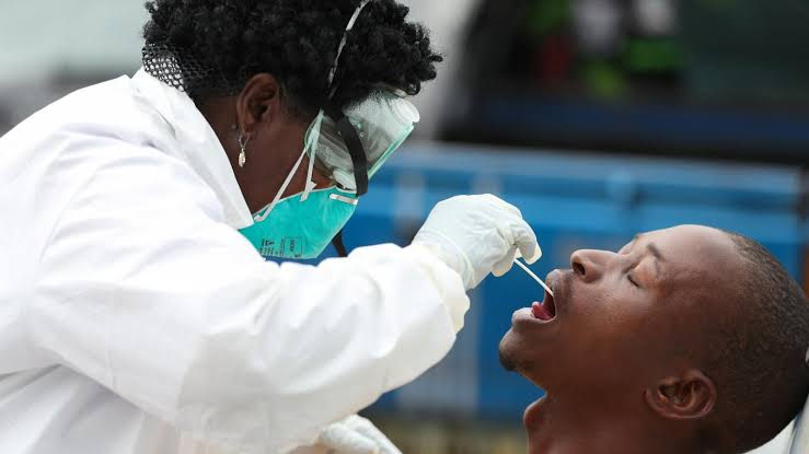 A health worker tests a patient for coronavirus.