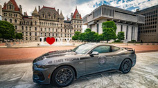 2025 Mustang GT patrol vehicle photographed at the Empire State Plaza in Albany, in front of the iconic I Love NY sign, with the State Capitol as a backdrop.