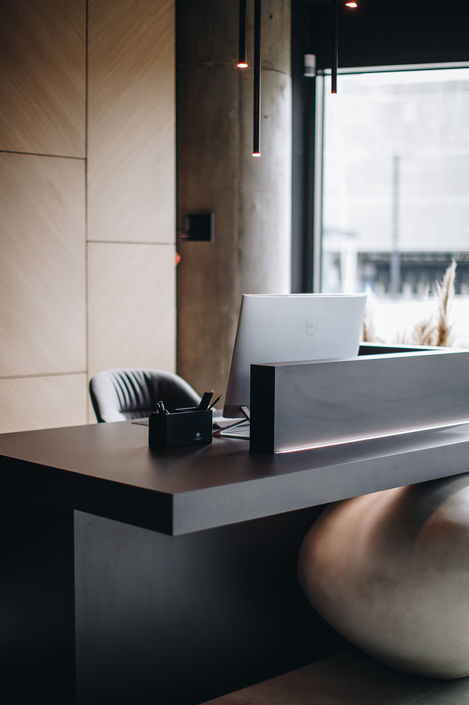 Modern reception desk with computer and phone.
