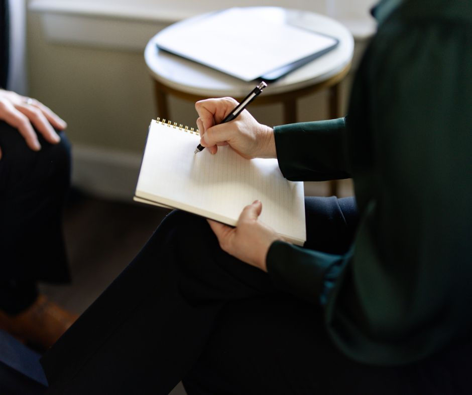 Ashley DeBoard taking notes in meeting