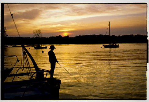 Child fishing at golden hour