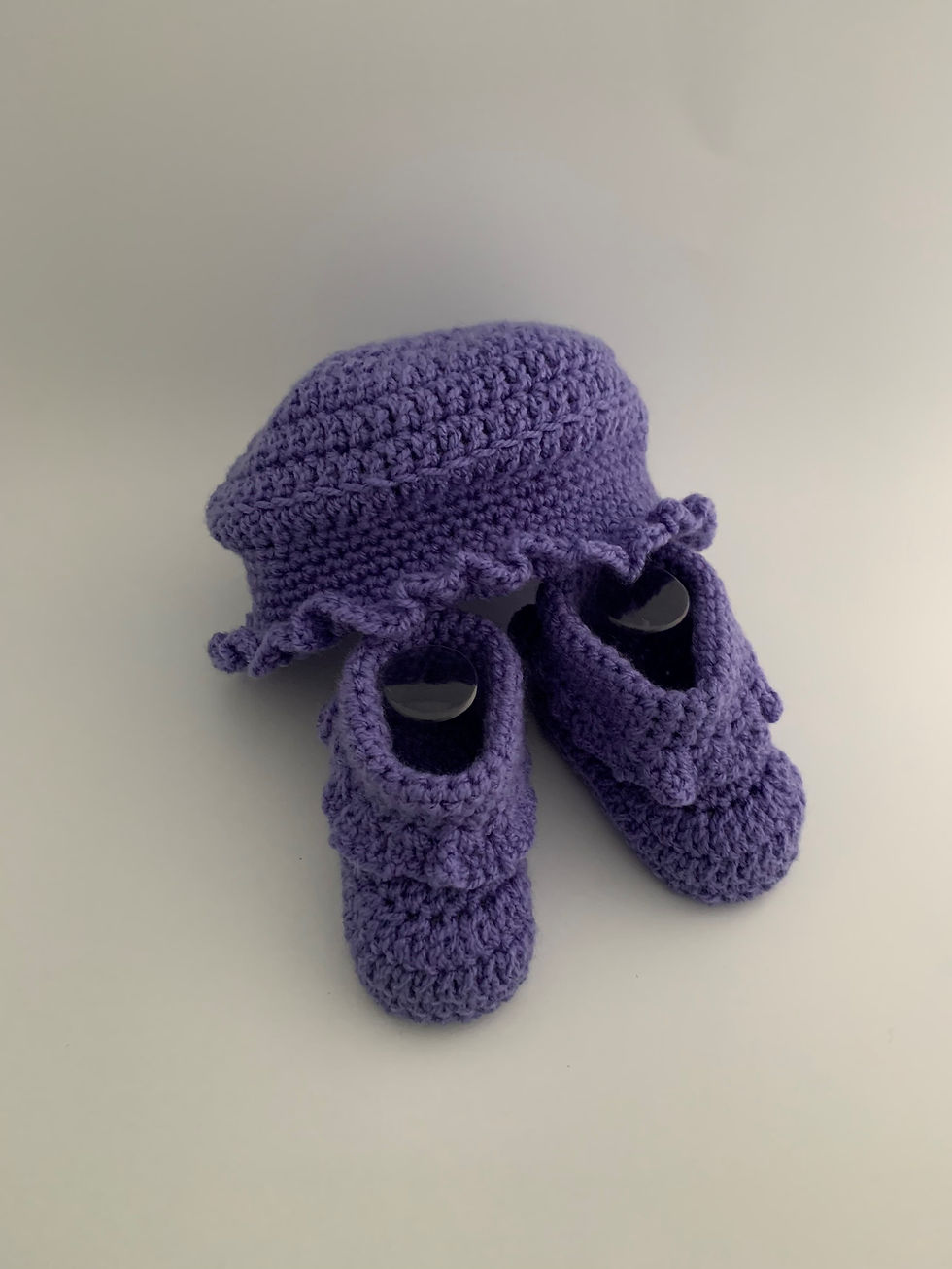 Purple crochet bucket hat with booties front view