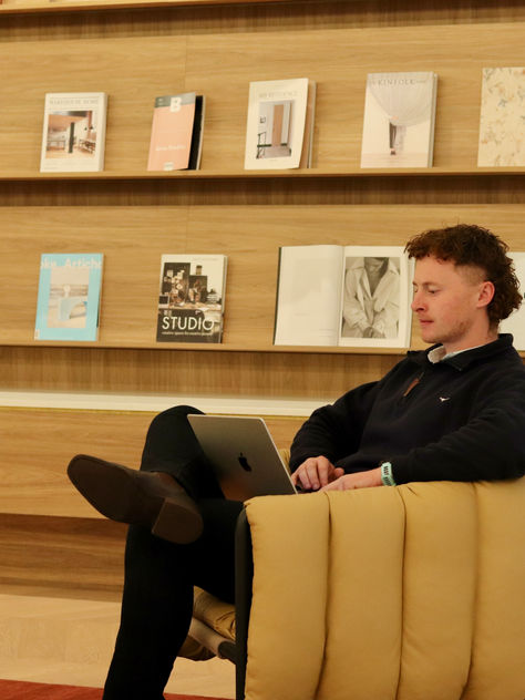 Tom sitting on a couch at ECLAT 
