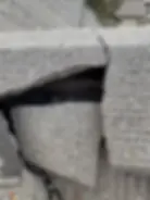 Close-up of a cracked and broken roof tile on a Prineville, Oregon home indicating roof damage