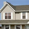 Beige house in Redmond with newly installed gutters and siding