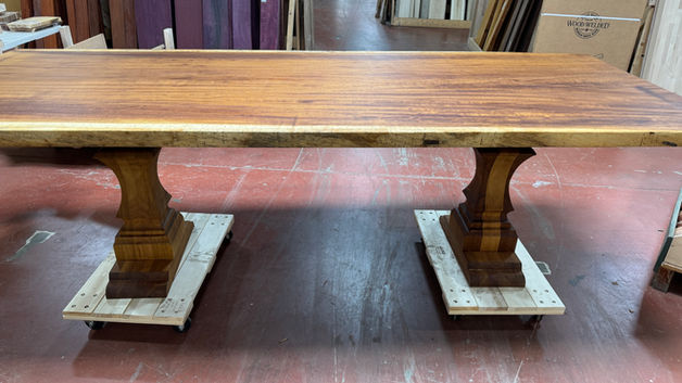 Live edge wood table with two carved pedestal bases