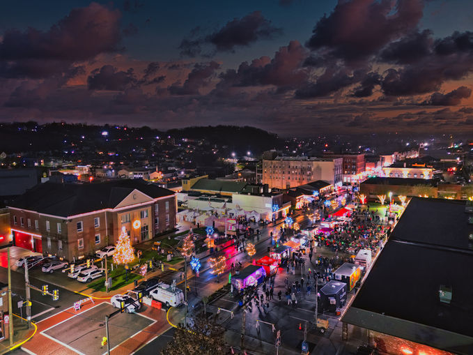 Night view of a town with lights and people enjoying Christmas.