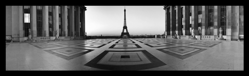 A striking black-and-white photograph of the Eiffel Tower viewed from the Palais de Chaillot, with symmetrical columns framing the scene and leading the eye toward the iconic monument in the distance. This image showcases Cristian Mitrani's talent for capturing architectural beauty and perspective in a dramatic, timeless style.