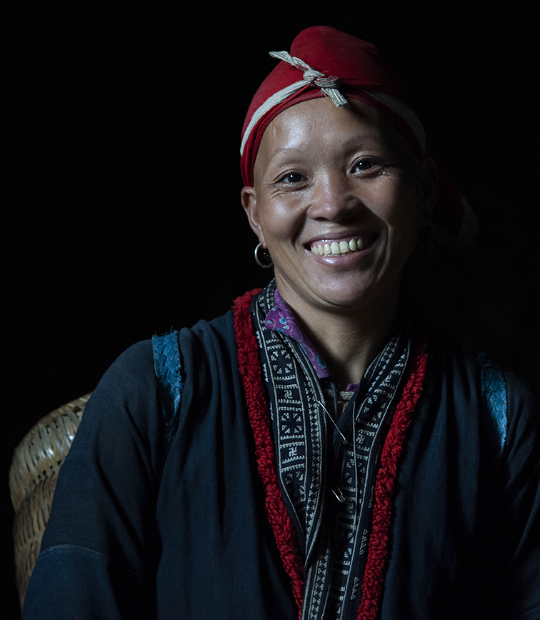 Smiling woman wearing traditional clothing and jewelry, radiating joy and cultural pride — a vibrant portrait by Cristian Mitrani.