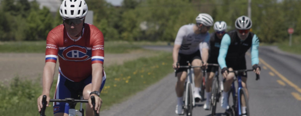 Cyclists participating in ACDA road-safety educational video campaign. One of the cyclist has a uniform of the Montreal Canadians bike professional apparel .