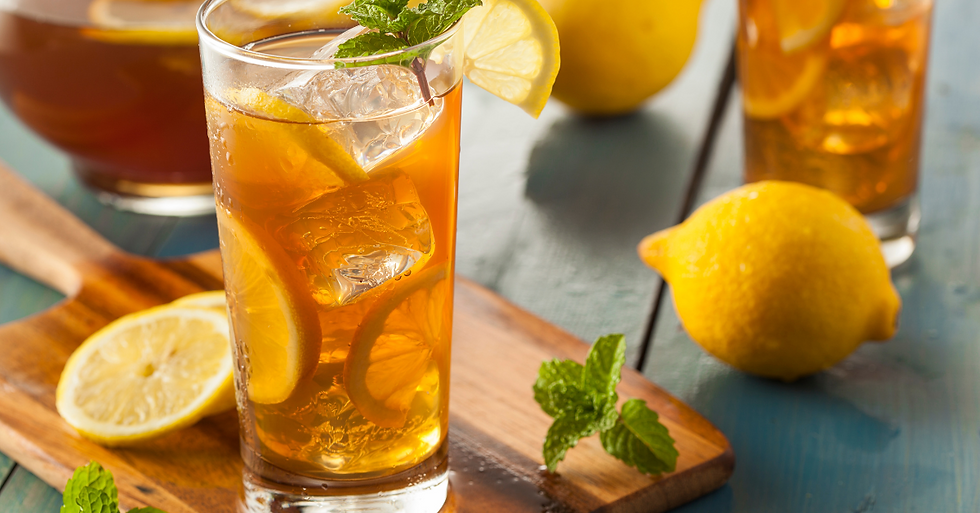 A glass of fizzy delicious cold tea with ice cubes and mint garnish