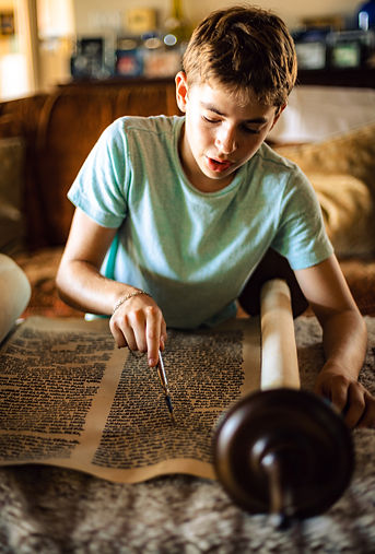 Young Boy reading from the Czech Torah