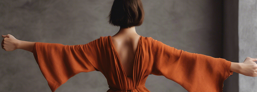 a horizontal image of a woman from the back moving her arms armoniously in warm colors suc