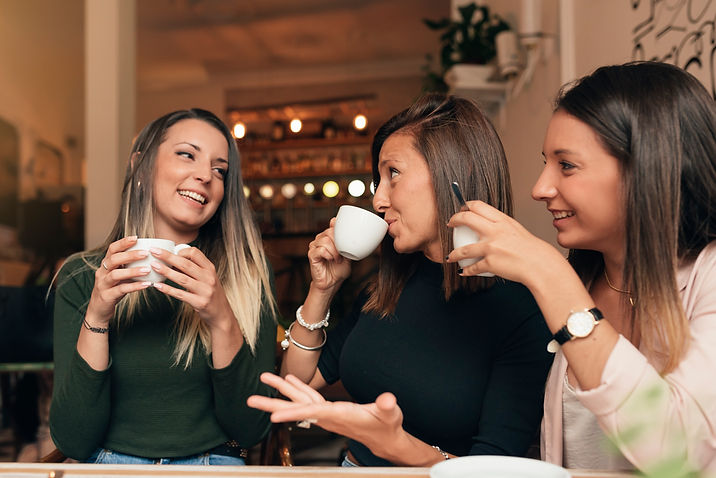 smiling-young-woman-drinking-coffee-restaurant.jpg