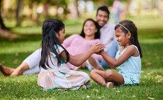family-playing-girls-nature-park-siblings-traditional-hand-games-grass-summer-break-parent