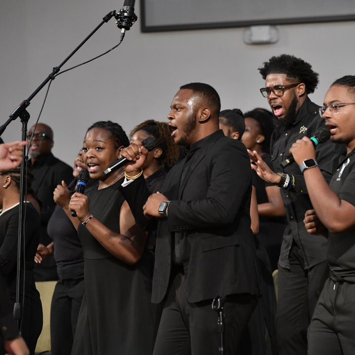 GMBSC choir members singing together during a worship service.