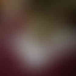 Flowers in a vase on a burgundy tablecloth with "Celebrating 40 Years" stickers and a marker nearby, creating a festive mood.