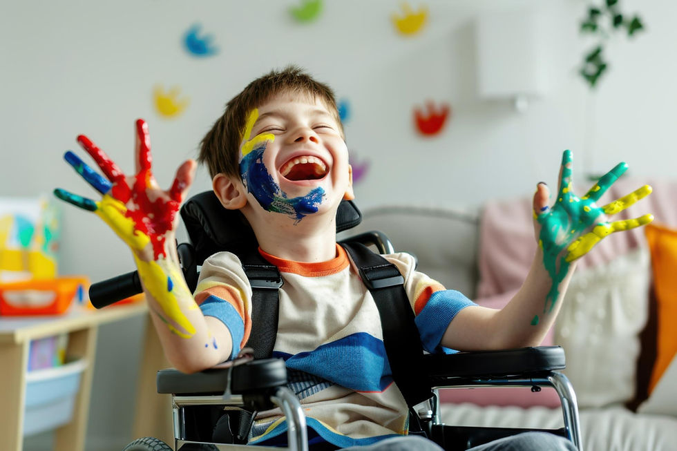 Disabled child in wheelchair playing with hands stained with paint