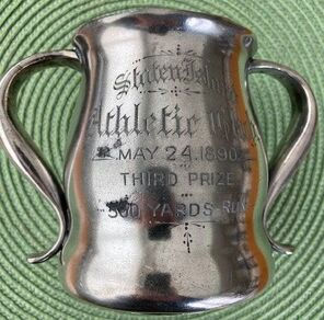 Third place trophy won by Walt Christie. Christie was not a SIAC member, but was a runner who participated in many races throughout New York City. He became a famous track coach in the 1920s and was the track and field coach for the 1924 Olympics.
