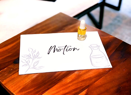 Motion Essential Oil Blend Sample 2ml on wood table.