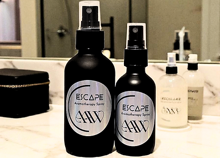 Escape Aromatherapy Spray image of both the 4oz and 2oz next to each other on bathroom countertop.