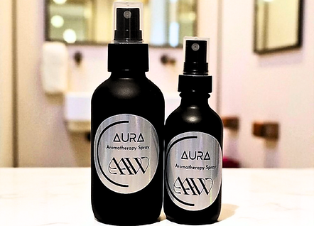 Aura Aromatherapy Spray image of both the 4oz and 2oz next to each other on bathroom countertop.