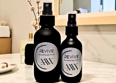 Revive Aromatherapy Spray image of both the 4oz and 2oz next to each other on bathroom countertop.